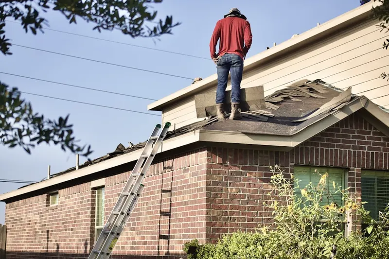 Professional roofer working on a residential roof in Cambridge Country